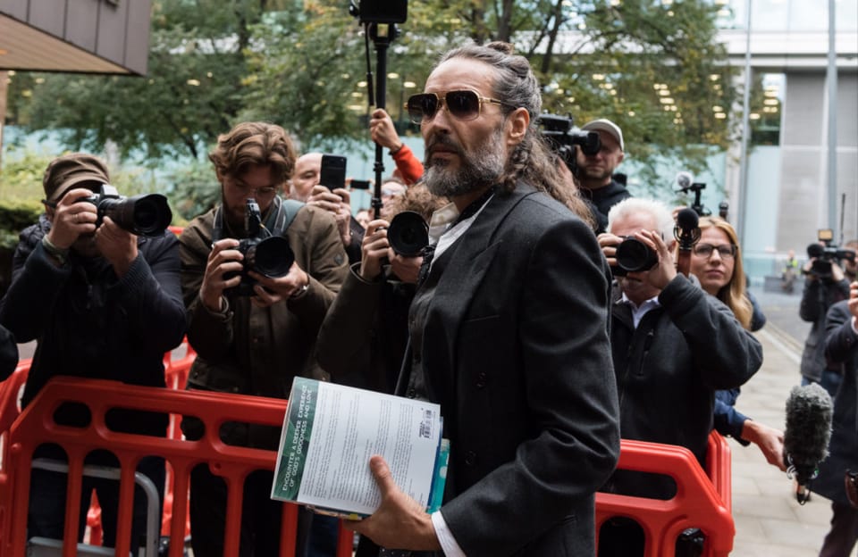 Russell Brand and his wife pray before court