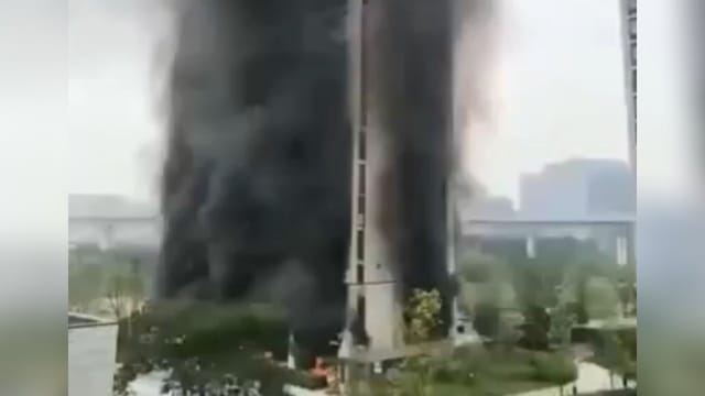 Flames and black smoke: Skyscraper on fire